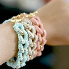 a close up of a person's arm wearing bracelets