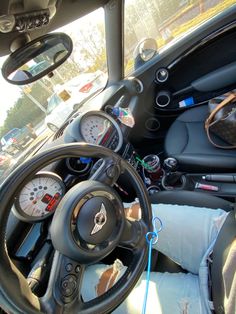 the interior of a car with steering wheel and dashboard