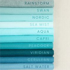 a stack of blue and green sheets with the names of different colors on them, all in