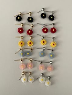 Fun, quirky, and full of personality - these acrylic resin dangle earrings feature charming daisy flowers and come in your choice of gold or silver earring posts. Choose your preferred flower dangle color to add a touch of playfulness to any outfit.- Stainless steel, Acrylic Resin- Daisy: 10x10mm- Stud ball: 4.8mm Trendy Flower Earrings, Trendy White Earrings With Flower Charm, Trendy Flower Shaped Earrings, Cute White Flower Earrings With 3d Design, Trendy Silver Flower Earrings, Cute White Flower Earrings With 3d Flowers, Cute Flower Charm Drop Earrings, Cute Flower Charm Earrings, Trendy 3d Flower Jewelry