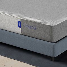 the original mattress topper is made from memory foam and has a blue logo on it