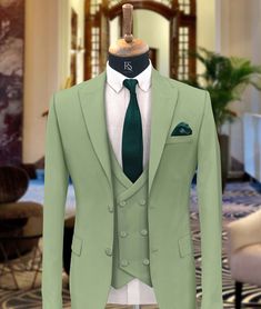 "Men Suits, Suits For men light green three piece Wedding Suit, Formal Fashion Slim Fit Tuxedo Suit  COMPULSARY  PLEASE MEASURE YOUR CHEST AREA, CIRCUMFRENECE AROUND THE BROADEST PART OF CHEST AND WAIST AREA WHERE YOU NORMALLY WEAR YOUR TROUSER OR 4 FINGER BELOW THE BELLY BUTTON, AND PICK YOUR SIZE ACCORDINGLY  PLEASE PROVIDE YOUR HEIGHT AND WEIGHT IN THE PERSONALISATION BOX , WHILE PLACING THE ORDER PLEASE CHECK THE SIZE CHART BEFORE PLACING THE ORDER IN SIZE CHART , \"WAIST\" REFERS TO THE AREA WHERE YOU NORMALLY WEAR YOUR TROUSERS. This Elegant Fashion 3 piece suit With Matching Vest And Trousers for Men Is Perfect For every one Who Loves formal Suits. This Designer Suit will be Handcrafted Specially For You only after You Place an Order. Fabric:- Terry Rayon Premium Includes:- Coat Ves Till Green Color, Light Green Tuxedo For Men, Fitted Green Wedding Suit, Green Double Breasted Notch Lapel Suit For Groom, Classic Green Blazer For Groom, Classic Green Wedding Blazer, Fitted Green Tuxedo For Groom, Green Fitted Tuxedo For Groom, Tailored Green Semi-formal Sets