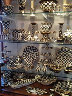 a display case filled with black and white checkered dishes