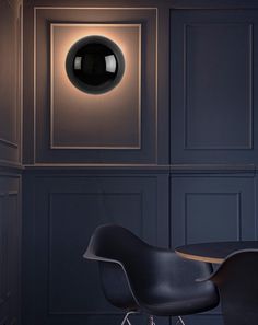 a black chair sitting in front of a round table