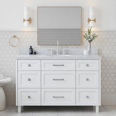 a bathroom vanity with two sinks and a mirror above it in front of a toilet