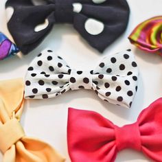 several different types of bow ties laid out on a white table with polka dot designs