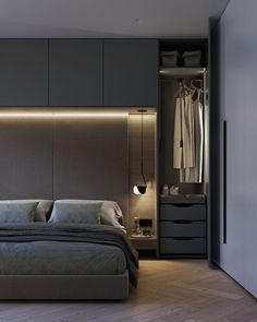 a bedroom with a bed, closet and dressing area in the corner is lit up by dim lighting