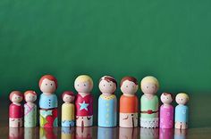 a group of wooden dolls standing next to each other