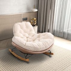 a rocking chair and ottoman in a living room with beige walls, rugs and curtains