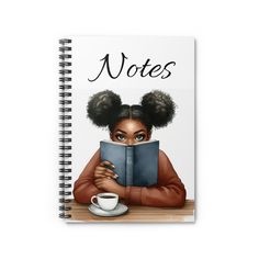 a spiral notebook with an illustration of a woman reading a book and holding a coffee cup