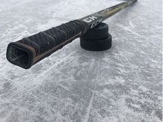 a close up of a hockey stick in the snow