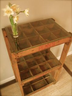 a vase with flowers on top of a wooden table next to a carpeted floor