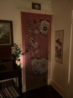 a room with a door covered in flowers next to a record player on a table