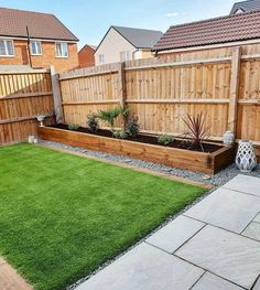 a backyard with grass and wooden fence