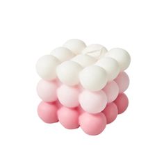 pink and white balloons stacked on top of each other