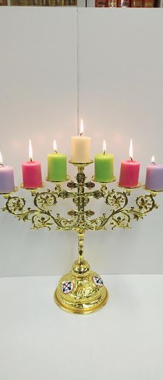 a golden candelabra with six lit candles