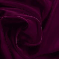 a close up view of a purple fabric with very soft folds and smooth lines on it