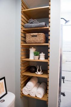 the shelves in this bathroom are filled with towels and other items, including toiletries