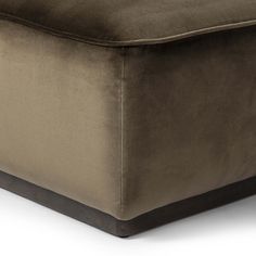 a brown ottoman that is sitting on the floor