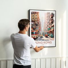 a man is looking at a poster on the wall