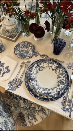 a table set with blue and white china