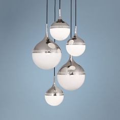 three chrome colored lights hanging from a ceiling in a room with blue walls and flooring