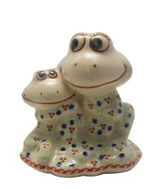 a ceramic frog figurine sitting on top of it's back