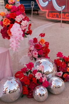 flowers and disco ball decorations on the sidewalk