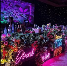 the bar is decorated with neon lights and flowers