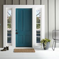 a blue front door with two windows and a rug on the floor next to it