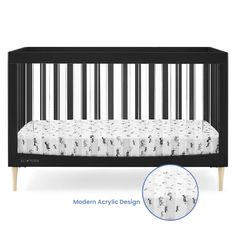 a black crib with white sheets and wooden legs