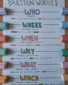 the question words are written on a piece of paper with colored pencils attached to it