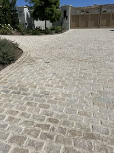 a brick driveway in front of a house