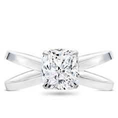 a cushion cut diamond engagement ring on a white background