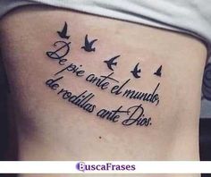 a woman's back with birds flying in the sky and words written on it