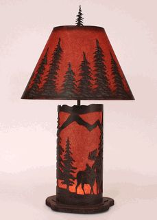 a lamp that is sitting on top of a wooden stand with a red shade over it