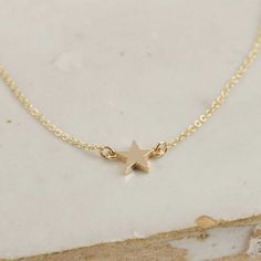 "Delicate gold star on a fine classic trace chain that sits just on the collar. Made from solid 9 ct or 18 ct yellow gold, this creates a gentle twinkle for everyday. Perfect on it's own as well as layered up with longer styles. Made from solid 9 ct or 18 ct yellow gold Made to order in  5 days Chain: 16\" delicate trace chain Star: 5 mm" Personalized Gold Jewelry, Gold Star Necklace, Star Necklace Gold, Coin Ring, Gold Star, Delicate Necklace, Star Charms, Star Necklace, Gold Stars