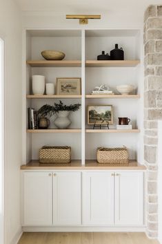 the shelves have baskets and vases on them, along with other items such as bookshelves