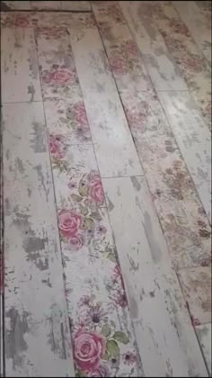 an old wooden floor with pink roses on it