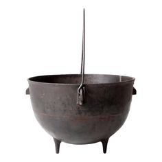 an old metal bowl with two handles and a hook on the handle is shown against a white background