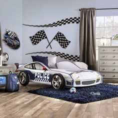 a child's bedroom with a police car bed