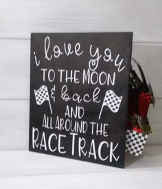 a sign that says i love you to the moon and back all around the race track