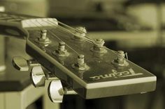 an electric guitar neck with knobs on it's head and the frets