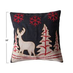 a christmas pillow with reindeer and trees on it