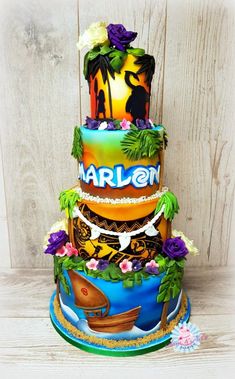 there is a multi layer cake decorated with palm trees and flowers on top, along with the words marlenn