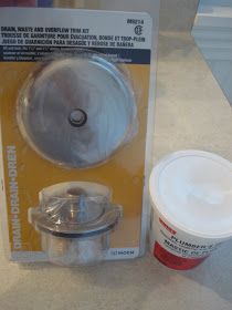 a plastic container with a lid next to a cup on a counter top in a package