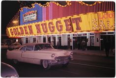 an old car is parked in front of the golden nugget