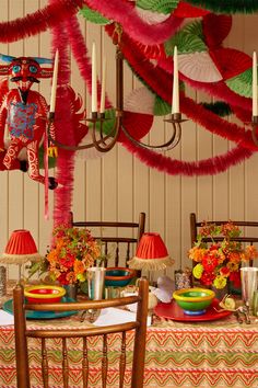 the table is set with colorful decorations and candles