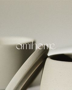 two white cups sitting next to each other on top of a table with the word omnihome written above them