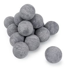 a pile of gray rocks sitting next to each other on top of a white surface